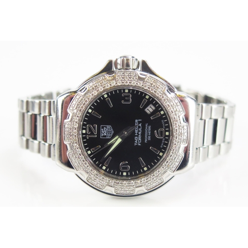 425 - A TAG Heuer Formula 1 Diamond Bezel Black Dial Wristwatch on TAG steel bracelet together with box, g... 