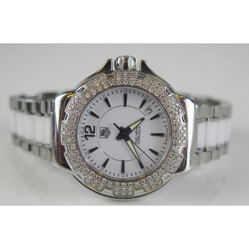 427 - A TAG Heuer Formula 1 Diamond Bezel White Dial Wristwatch on TAG steel and white ceramic bracelet to... 