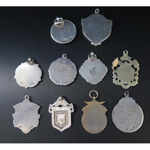 562 - Nine assorted silver fobs and medallions, various makers and dates, and a plated example, total weig... 