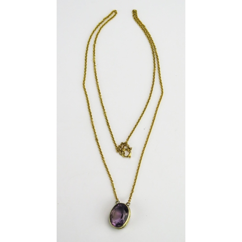 59 - A 9ct Gold and Amethyst Pendant on an integral chain, 14.6x10.8mm oval rub over set stone, 21