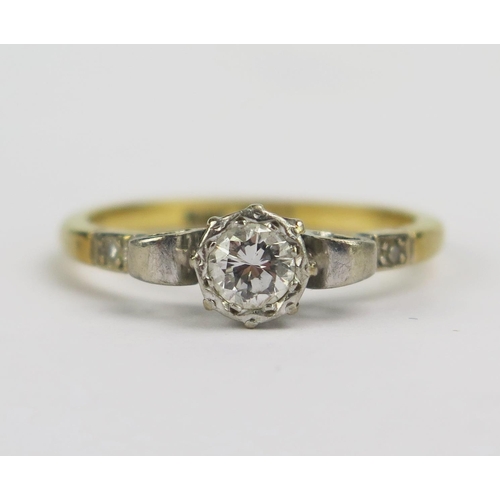 62 - An 18ct Gold and Diamond Solitaire Ring, c. 4.5mm brilliant round cut stone with accent stones to th... 