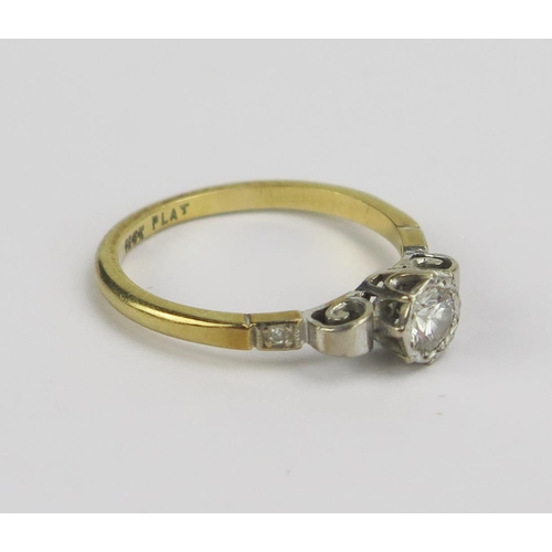 62 - An 18ct Gold and Diamond Solitaire Ring, c. 4.5mm brilliant round cut stone with accent stones to th... 