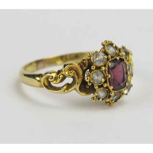 63 - A 19th Century Precious Yellow Metal and Paste Ring with pierced rococo scroll shoulders, size N.25,... 