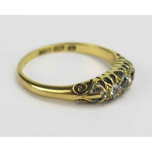 65 - A Victorian 18ct Gold and Diamond Five Stone Ring, largest old cut c. 3.65mm claw set with chased sc... 