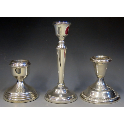 676 - Three assorted silver candlesticks various makers and dates, all with weighted bases, 16cm, 10cm and... 