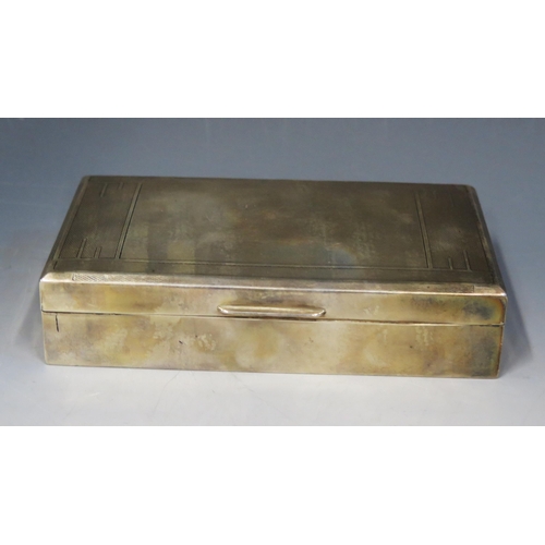 681 - A 20th century silver cigarette box, all marks worn, of rectangular outline with engine turned decor... 