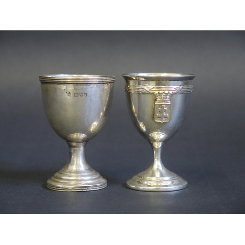 696 - An Edward VII silver egg cup, makers mark worn, Chester, 1903, together with a French silver example... 