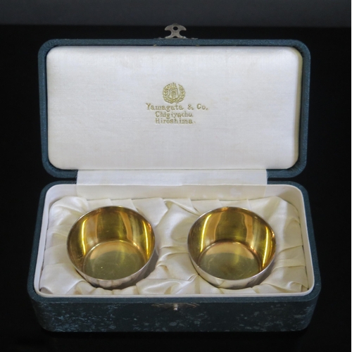 704 - A pair of Japanese sake cups, of plain circular form, with gilded interior, on a circular foot, 4.5c... 