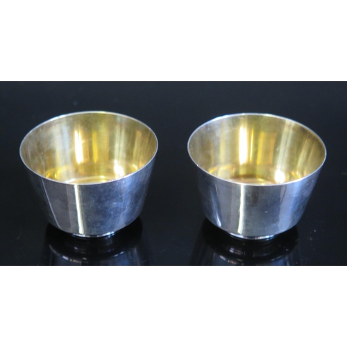 704 - A pair of Japanese sake cups, of plain circular form, with gilded interior, on a circular foot, 4.5c... 