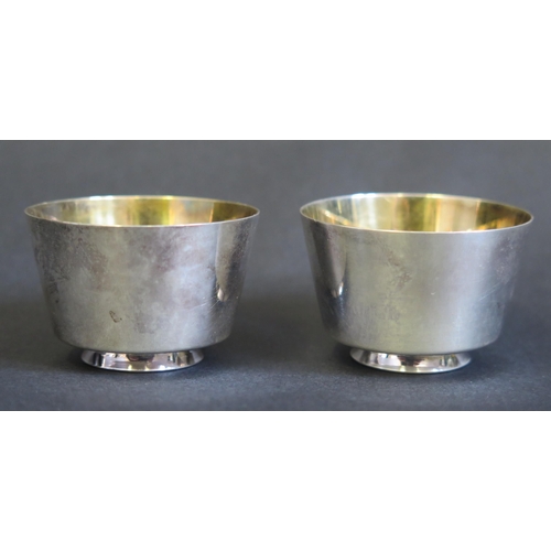 704 - A pair of Japanese sake cups, of plain circular form, with gilded interior, on a circular foot, 4.5c... 