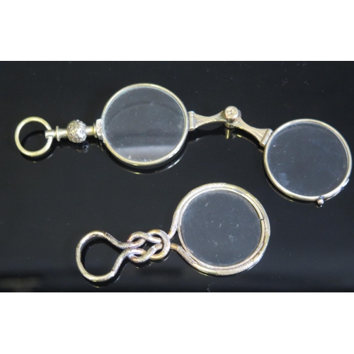 706 - A pair of 19th century gilt metal framed lorgnettes, together with a gilt metal framed monocle. (2).