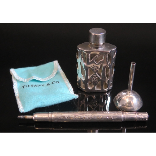 714 - A clear glass and silver mounted scent bottle 5.5cm high, together with a white metal funnel contain... 