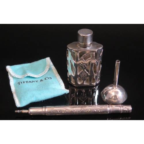 714 - A clear glass and silver mounted scent bottle 5.5cm high, together with a white metal funnel contain... 