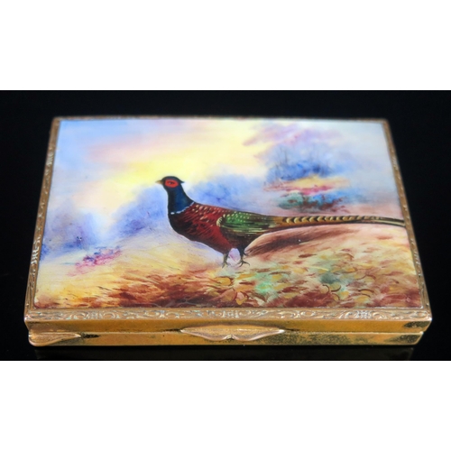 723 - A gilt metal and enamel snuff box, of rectangular outline the lid decorated with a pheasant, 8cm wid... 