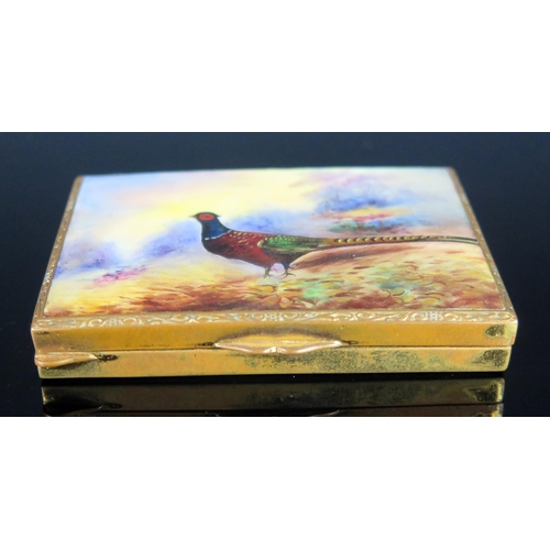 723 - A gilt metal and enamel snuff box, of rectangular outline the lid decorated with a pheasant, 8cm wid... 