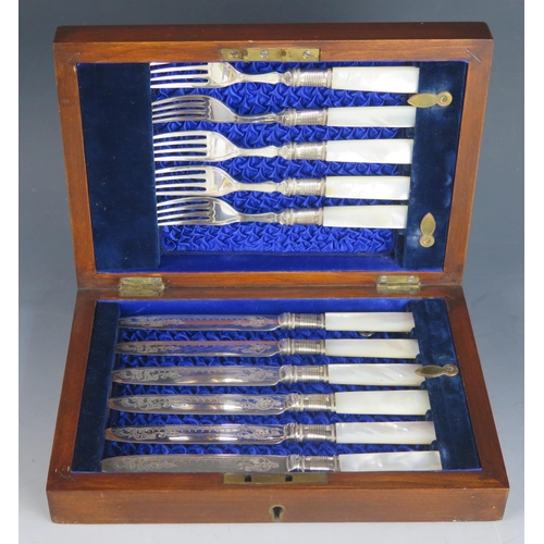 735 - A set of five mother-of-pearl handled fruit knives and forks contained in a mahogany case.