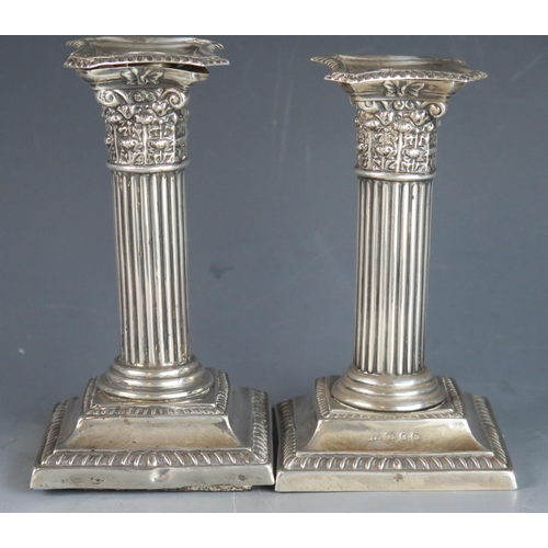 740 - A pair of Victorian Corinthian column candlesticks, all marks worn, London, Birmingham, 1897, on wei... 