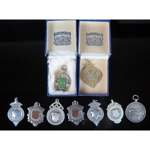 765 - A collection of silver and plated fobs and medallions, various makers and dates. (a lot).