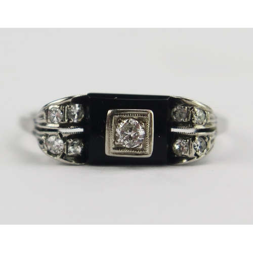 78 - A French Deco 14ct White Gold, Diamond and Onyx Ring, c. 2.5mm principal stone, various marks and st... 