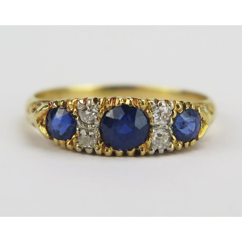 81 - An 18ct Gold, Sapphire and Diamond Ring with scrolling decoration to the shank, 4.2mm principal ston... 