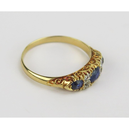 81 - An 18ct Gold, Sapphire and Diamond Ring with scrolling decoration to the shank, 4.2mm principal ston... 