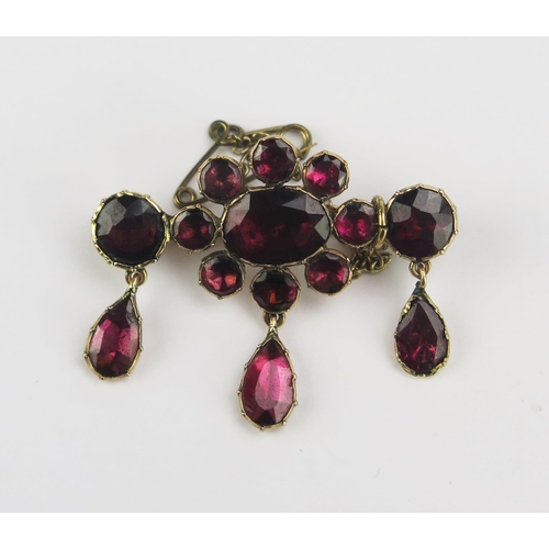 90 - A Georgian Foil Backed Garnet Brooch in a precious yellow metal setting with three suspended pear sh... 