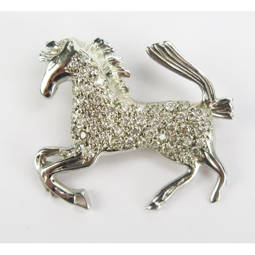 97 - A 9ct White Gold and Diamond Horse Pendant, 26mm long, hallmarked, maker A & A, 3.53g