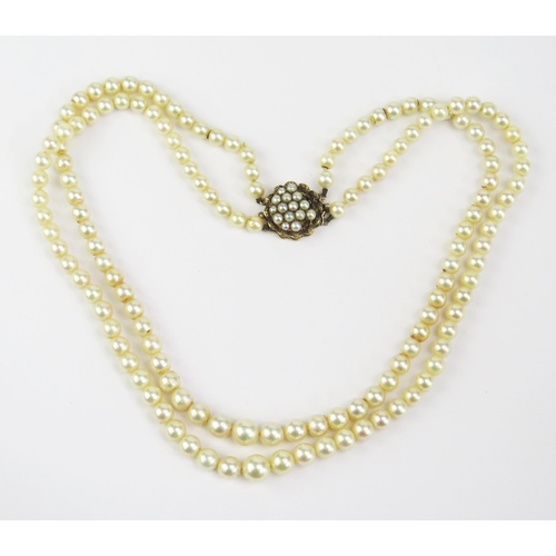 131 - A Graduated Pearl or Cultured Pearl Twin Strand Necklace with 9ct clasp, 17.25