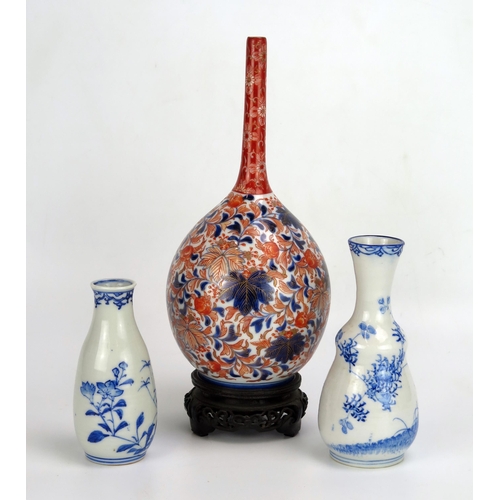 1528 - A Japanese Imari porcelain bottle vase, of ovoid form with slender neck, with all over floral decora... 