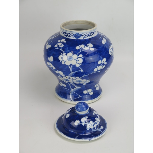 1531 - A Chinese blue and white vase and cover of baluster form with all-over prunus decoration, 30cm high,... 