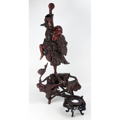 1535 - A Chinese carved root wood figure of a dancing man, 66cm high, a wood stand, a carved wood plaque an... 