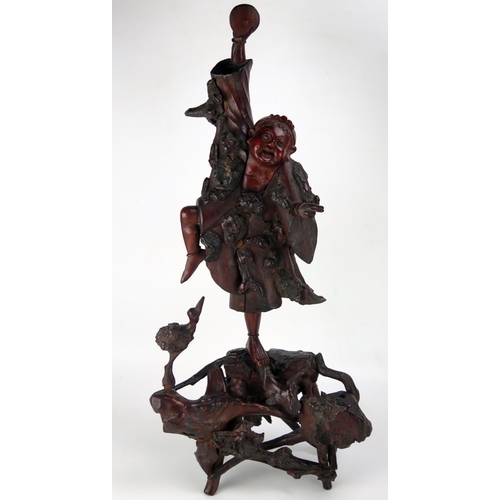 1535 - A Chinese carved root wood figure of a dancing man, 66cm high, a wood stand, a carved wood plaque an... 