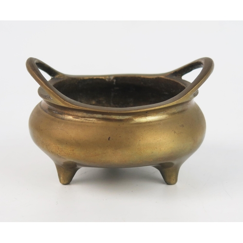 1536 - A Chinese circular bronze tripod censer, with swept loop handles, bears six character Xuande mark to... 