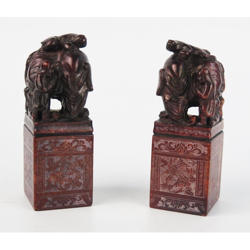 1537 - A pair of Chinese carved hardstone seal, of rectangular outline surmounted with figures and an eleph... 