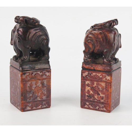 1537 - A pair of Chinese carved hardstone seal, of rectangular outline surmounted with figures and an eleph... 