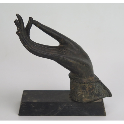 1538 - An Indian bronze model of a hand held in a gesture of debate (Vitarka Mudra), mounted on a wood base... 