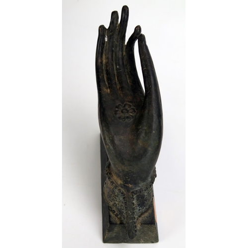 1538 - An Indian bronze model of a hand held in a gesture of debate (Vitarka Mudra), mounted on a wood base... 