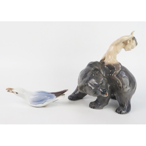 1671 - A Royal Copenhagen porcelain model of a satyr riding on the back of a bear, model No 976, 19cm high,... 