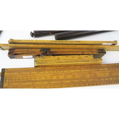 1673 - A collection of folding rulers, slide rules, rolling rulers, etc.