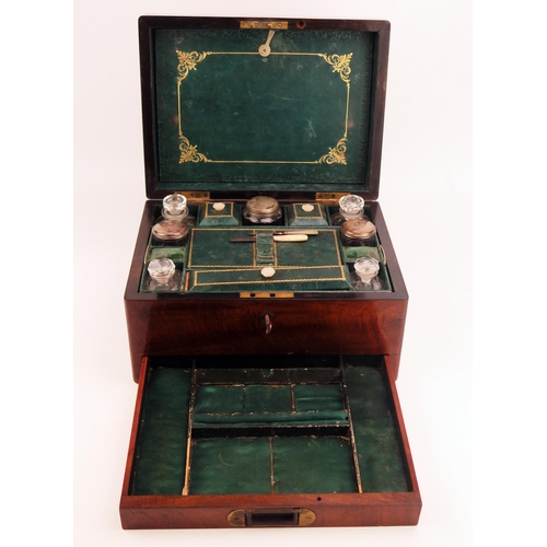 1680 - A Victorian mahogany travelling vanity box, the hinged lid enclosing a fitted interior of silver pla... 