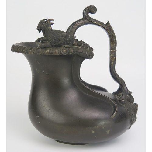 1683 - A 19th century bronze jug, of gourd shape outline the rim surmounted by two goats, with scroll handl... 