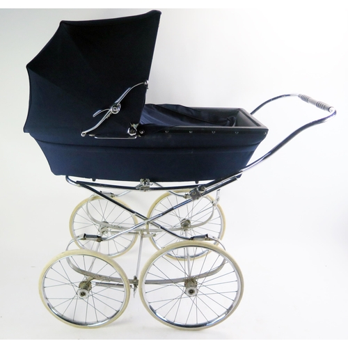 1689 - A Marmet child's pram, with hinged hood, mounted with spoked wheels and solid rubber tyres.