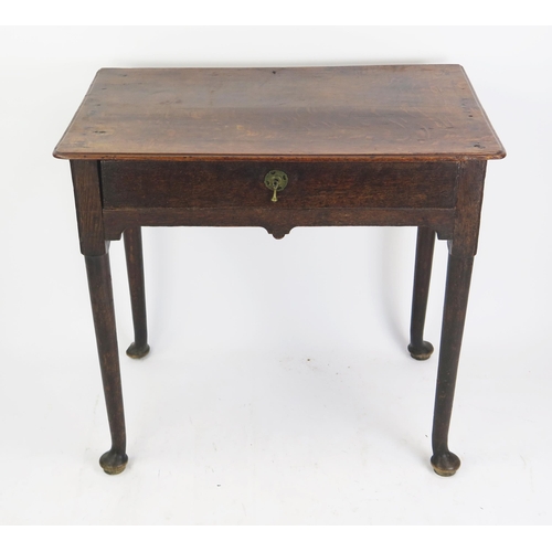 1695 - A late 18th century oak side table, the rectangular top with a moulded edge, having a single long fr... 