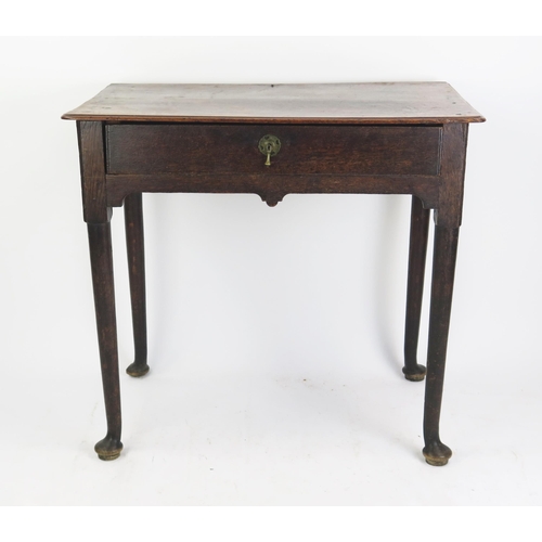 1695 - A late 18th century oak side table, the rectangular top with a moulded edge, having a single long fr... 