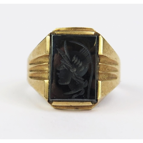 186 - A 9ct Gold and Hematite Signet Ring engraved with the bust of a helmeted soldier, size R.5, London i... 