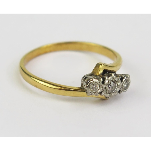 189 - A Diamond Three Stone Crossover Ring in a precious yellow and white metal setting, size Q.5, KEE tes... 