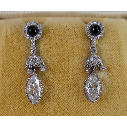 267 - A Pair of Diamond and Onyx Drop Pendant Earrings in a platinum setting, c. 7.8x4.7mm marquis cut pri... 