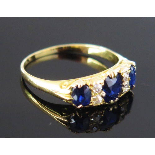 268 - A Sapphire and Diamond Seven Stone Ring in a precious yellow metal setting, c. 5.8x5mm principal sto... 