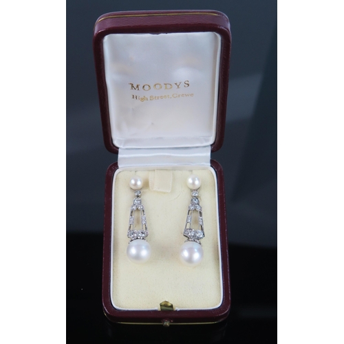 269 - A Large Pair of Cultured Pearl and Diamond Drop Pendant Earrings in a precious white metal setting, ... 