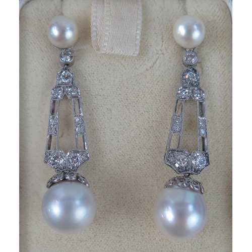 269 - A Large Pair of Cultured Pearl and Diamond Drop Pendant Earrings in a precious white metal setting, ... 